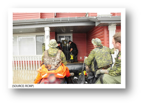 Photo of locksmiths opening the door of an evacuated house in the Town of High River.